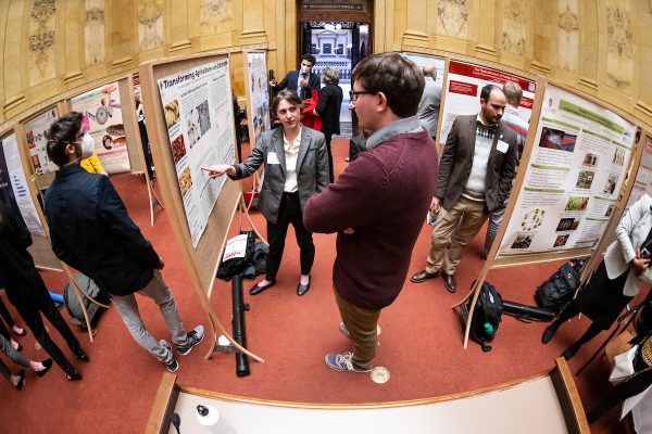 At left of center, Chandler Meyer, graduate student in the Department of Horticulture, Plant Breeding and Genetics Program, present information on her research project about transforming agriculture with CRISPR to fellow students, legislators and staff during UWMadison Day at the Capitol, a University of WisconsinMadison advocacy and outreach event held at the Wisconsin State Capitol on April 27, 2022. (Photo by Jeff Miller / UWMadison)