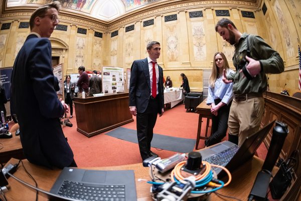 At center, Rep. Daniel Riemer of Assembly District 7 listens as UW-Madison students, left to right, Josh Murwin, Sara Harper and Dylan Schmitz talk about developments in robotics and sensing in rehabilitation biomechanics during UWMadison Day at the Capitol, a University of WisconsinMadison advocacy and outreach event held for legislators and staff at the Wisconsin State Capitol on April 27, 2022. (Photo by Jeff Miller / UWMadison)