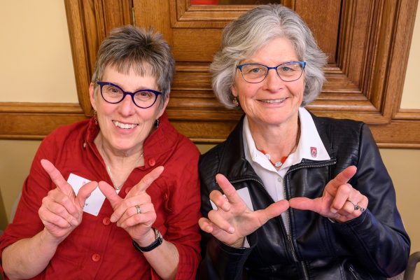 “It’s good to see Badgers all over the place.” From left to right, Nancy Schake and Diane Opperman, members of the Wisconsin Alumni Association pause from their meetings with lawmakers to throw a W and listen in on Faculty Flash Talks during the UW–Madison's Day at the Capitol, a University of Wisconsin–Madison advocacy and outreach event held for legislators and staff at the Wisconsin State Capitol on April 26, 2023. The outreach event included a Graduate Research Showcase held in the Wisconsin State Capitol rotunda and Faculty Flash Talks by leading UW–Madison faculty researchers held in the Capitol’s 411 South. (Photo by Althea Dotzour / UW–Madison)