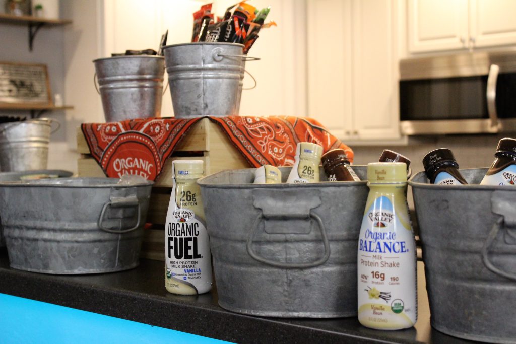 Decoratove metal Buckets are surounded by milk bottles