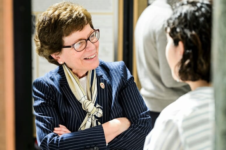 UW-Madison Chancellor Rebecca Blank listens to student Liliana Lule talk about her research project. Sen. Fred Risser listens to UW-Madison student Morgan Sanger talk about her and her teammates' research project.