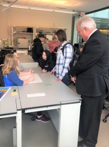 students and adults in a lab