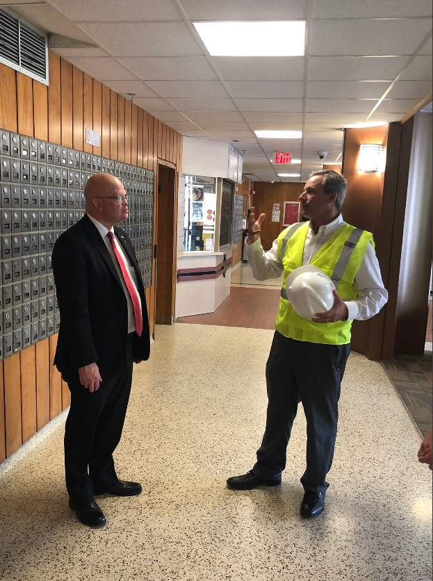 Two men talking in hallway