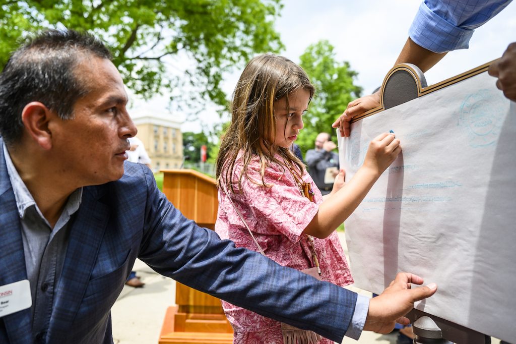 Man and young girl making a shading of a plaque
