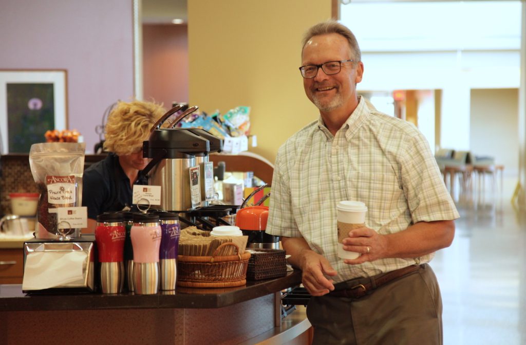 man holding coffee cup